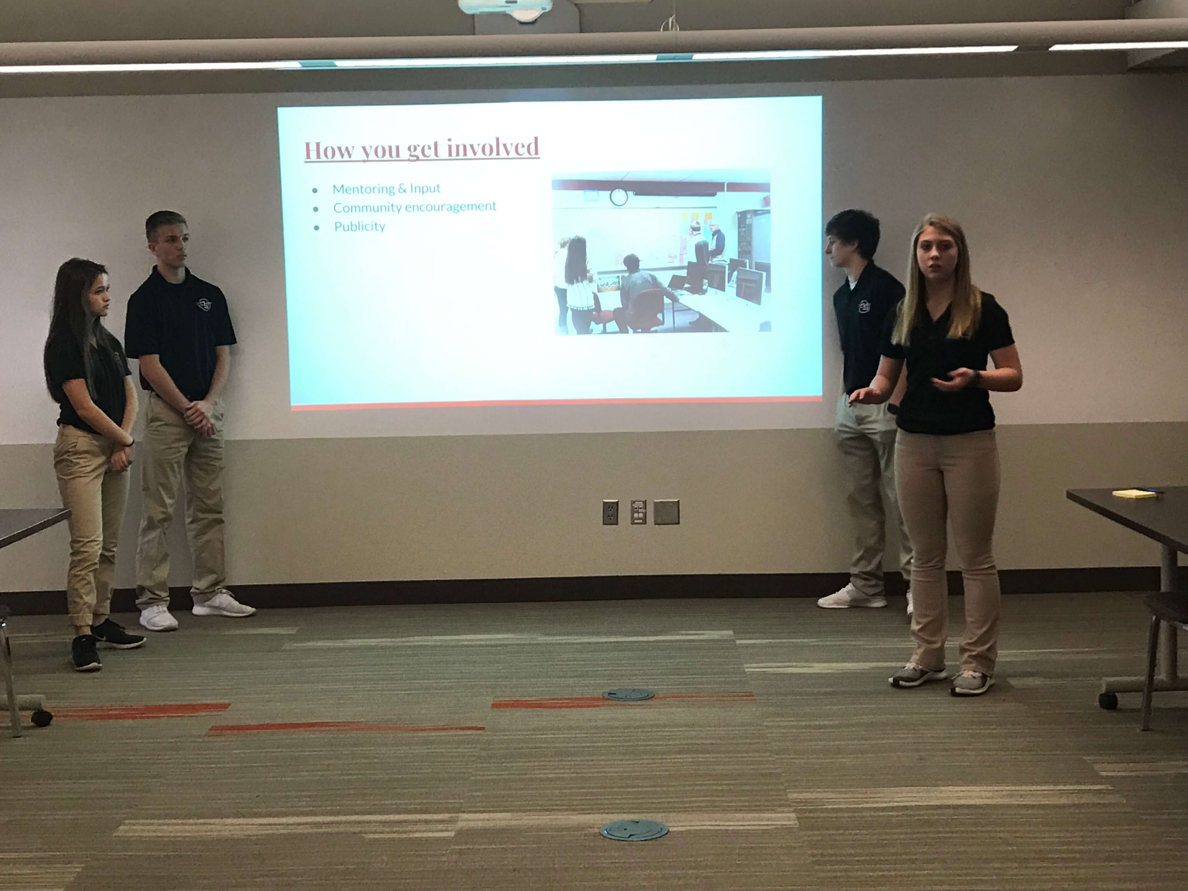 four students give a presentation